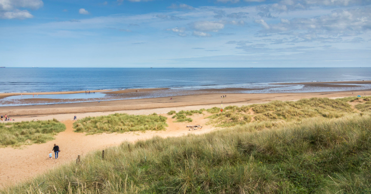 View of Crimdon Dene Beach on a bright sunny day with blue sky